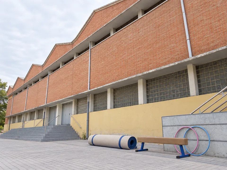 AI-generated illustration: empty Cabanyal-Canyamelar sports hall exterior with a gymnastics mat, training beam and two hoops.
