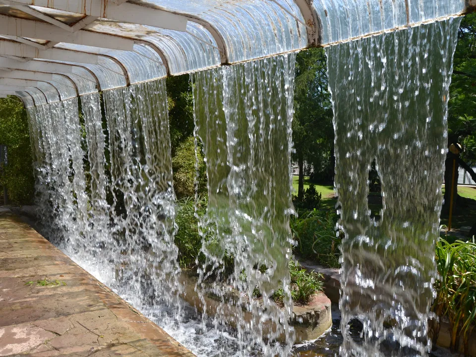 Sheets of water falling from an artificial waterfall in Parque de Benicalap, Valencia.