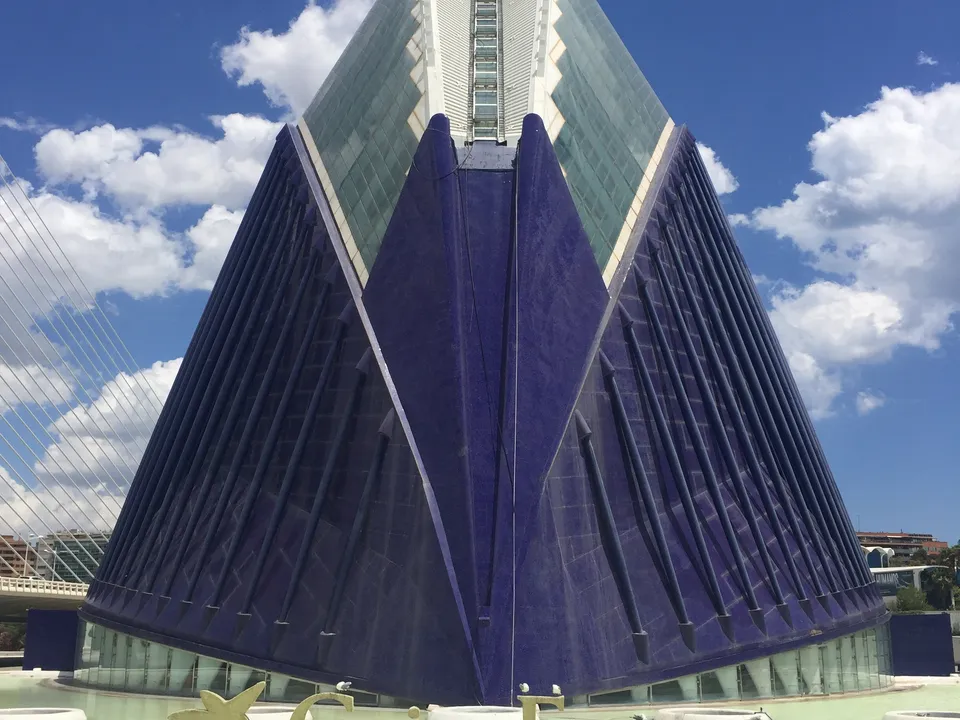 Purple exterior of CaixaForum València beneath a blue sky.