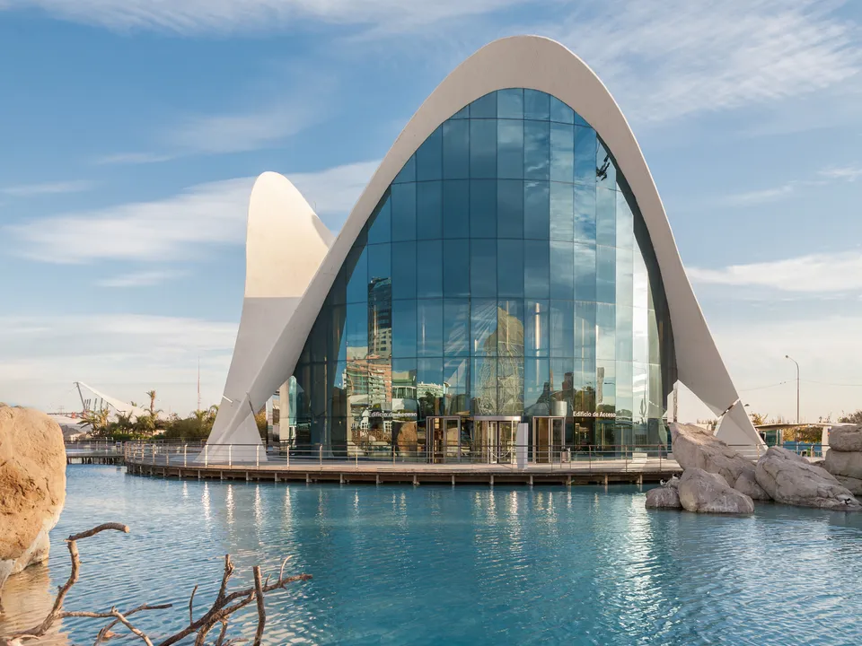 Main entrance building of Oceanogràfic València viewed across the water.